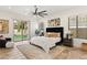 Comfortable bedroom featuring natural light, plush carpet, and a sliding glass door to the backyard at 50 Carolina Cherry Dr, Las Vegas, NV 89141
