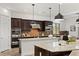 Modern kitchen with an island, granite countertops, stainless steel appliances and wooden cabinetry at 50 Carolina Cherry Dr, Las Vegas, NV 89141