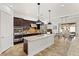 Elegant kitchen with stainless steel appliances, granite counters, and a dining area nearby at 50 Carolina Cherry Dr, Las Vegas, NV 89141