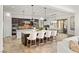Open kitchen with an expansive island, seating, granite countertops, and pendant lighting at 50 Carolina Cherry Dr, Las Vegas, NV 89141