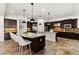 Spacious open kitchen with granite countertops, a center island, and dark wood cabinetry at 50 Carolina Cherry Dr, Las Vegas, NV 89141