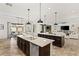Spacious kitchen featuring dual islands with granite countertops, stainless steel appliances, and dark wood cabinetry at 50 Carolina Cherry Dr, Las Vegas, NV 89141