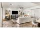 Bright living room with modern furnishings, large TV, ceiling fan, and neutral color palette at 50 Carolina Cherry Dr, Las Vegas, NV 89141