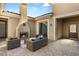 Stylish outdoor patio with modern fireplace, cozy seating, and paver flooring at 50 Carolina Cherry Dr, Las Vegas, NV 89141