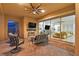 A covered patio with brick flooring, a fireplace, comfortable furniture, and sliding glass doors at 50 Carolina Cherry Dr, Las Vegas, NV 89141