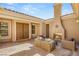 Inviting outdoor patio with a fireplace and comfortable seating area perfect for relaxing and entertaining at 50 Carolina Cherry Dr, Las Vegas, NV 89141