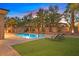Beautiful pool with lush landscaping, lounge chairs, and a water feature at 50 Carolina Cherry Dr, Las Vegas, NV 89141