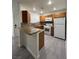 Bright kitchen with wood cabinetry, breakfast bar, modern appliances and vinyl flooring at 5044 S Rainbow Blvd # 106, Las Vegas, NV 89118