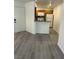 Bright kitchen featuring wood cabinetry, white appliances and vinyl flooring at 5044 S Rainbow Blvd # 106, Las Vegas, NV 89118
