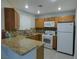 Well-lit kitchen boasts granite counters, mosaic backsplash, and modern appliances at 5044 S Rainbow Blvd # 106, Las Vegas, NV 89118