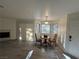 Bright living area featuring a fireplace, a table, and natural light from large windows at 5044 S Rainbow Blvd # 106, Las Vegas, NV 89118