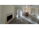 Open concept living room featuring fireplace, sliding door, and dining area with natural light at 5044 S Rainbow Blvd # 106, Las Vegas, NV 89118