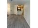 Living area featuring modern flooring that goes to the kitchen and a front door at 5044 S Rainbow Blvd # 106, Las Vegas, NV 89118