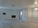 Spacious living room with fireplace, patio access, and neutral wall colors at 5044 S Rainbow Blvd # 106, Las Vegas, NV 89118