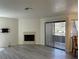 Open living room features fireplace, sliding glass door, and hardwood flooring at 5044 S Rainbow Blvd # 106, Las Vegas, NV 89118