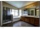 Bathroom featuring double sinks, a shower stall, and bathtub at 5115 Blossom Ave, Las Vegas, NV 89142