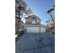 Two story home featuring a spacious three car garage, manicured yard, and neutral paint at 5115 Blossom Ave, Las Vegas, NV 89142
