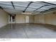 Attached garage featuring concrete flooring, lots of room for parking and door to interior at 5115 Blossom Ave, Las Vegas, NV 89142