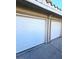 Exterior view of a two-car garage showcasing white garage doors and the home's facade at 5115 Blossom Ave, Las Vegas, NV 89142