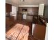 Kitchen with tile flooring, granite countertops, tile backsplash, and dark wood cabinets at 5115 Blossom Ave, Las Vegas, NV 89142