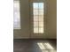 This living area features gray wood-look flooring and a backyard door for access at 5115 Blossom Ave, Las Vegas, NV 89142