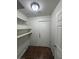 Walk-in pantry with adjustable shelving and ceramic tiled flooring at 5115 Blossom Ave, Las Vegas, NV 89142