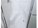 Clean white shower featuring built-in seating and clear glass door enclosure at 5115 Blossom Ave, Las Vegas, NV 89142