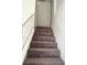 Carpeted stairway with metal railing leading to the upper level at 5115 Blossom Ave, Las Vegas, NV 89142