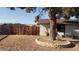 Spacious backyard with wood fence and mature tree in a decorative rock border at 5284 Wellesley Ave, Las Vegas, NV 89122