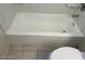 A close up of a standard tub in a small bathroom at 5284 Wellesley Ave, Las Vegas, NV 89122