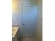A close up of a bathroom door, tile flooring, and sink at 5284 Wellesley Ave, Las Vegas, NV 89122