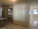 Bright living room with tiled floors and natural light from large windows, showcasing a spacious and inviting area at 5284 Wellesley Ave, Las Vegas, NV 89122