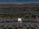 Aerial view of the home in a neighborhood near a golf course and desert landscape at 5467 Eleganza Ave, Pahrump, NV 89061