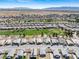 Aerial view of a residential neighborhood with a golf course and desert landscape at 5467 Eleganza Ave, Pahrump, NV 89061