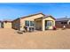 Backyard with neutral rock landscaping, covered patio, and outdoor furniture at 5467 Eleganza Ave, Pahrump, NV 89061