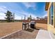 Backyard featuring a grill, outdoor kitchen prep area, and neutral rock landscaping at 5467 Eleganza Ave, Pahrump, NV 89061