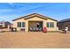 Backyard with neutral rock landscaping, covered patio, and outdoor furniture at 5467 Eleganza Ave, Pahrump, NV 89061