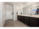 Well-lit bathroom featuring double vanities, modern fixtures, and ample storage space at 5467 Eleganza Ave, Pahrump, NV 89061