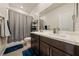 Bathroom featuring a dual sink vanity and a shower-tub combo with tile flooring at 5467 Eleganza Ave, Pahrump, NV 89061