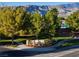 Inviting Mountain Falls community entrance with lush landscaping and picturesque mountain views at 5467 Eleganza Ave, Pahrump, NV 89061