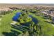 Scenic view of the lush golf course featuring a pond and mature trees at 5467 Eleganza Ave, Pahrump, NV 89061