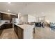 Open kitchen featuring stainless steel appliances, counter seating, and view of the dining area at 5467 Eleganza Ave, Pahrump, NV 89061