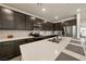 Modern kitchen with stainless steel appliances, quartz countertops and dark wood cabinetry at 5467 Eleganza Ave, Pahrump, NV 89061