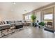 Comfortable living room with tile floors, large sectional sofa, and sliding glass doors at 5467 Eleganza Ave, Pahrump, NV 89061