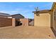 Fenced side yard with rock landscaping, privacy fence, and gate at 5467 Eleganza Ave, Pahrump, NV 89061