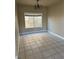 An elegant dining room with tiled floors, neutral paint, and a simple chandelier at 5758 Yellowcrest Ct, Las Vegas, NV 89113