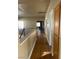 Upper-level hallway with laminate floors, neutral paint and wooden railing and cabinets at 5758 Yellowcrest Ct, Las Vegas, NV 89113
