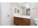 Well-lit bathroom featuring a wood vanity, a large mirror, and a toilet at 5855 Valley Dr # 1107, North Las Vegas, NV 89031