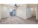 Inviting bedroom with plush carpeting, ceiling fan, and sliding glass door leading outside at 5855 Valley Dr # 1107, North Las Vegas, NV 89031