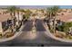 Gated community entrance lined with palm trees, desert landscape, and manicured hedges at 5855 Valley Dr # 1107, North Las Vegas, NV 89031
